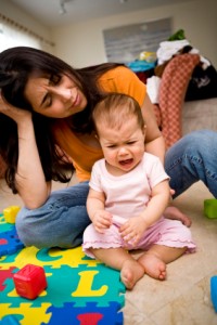 Woman and crying baby Picture